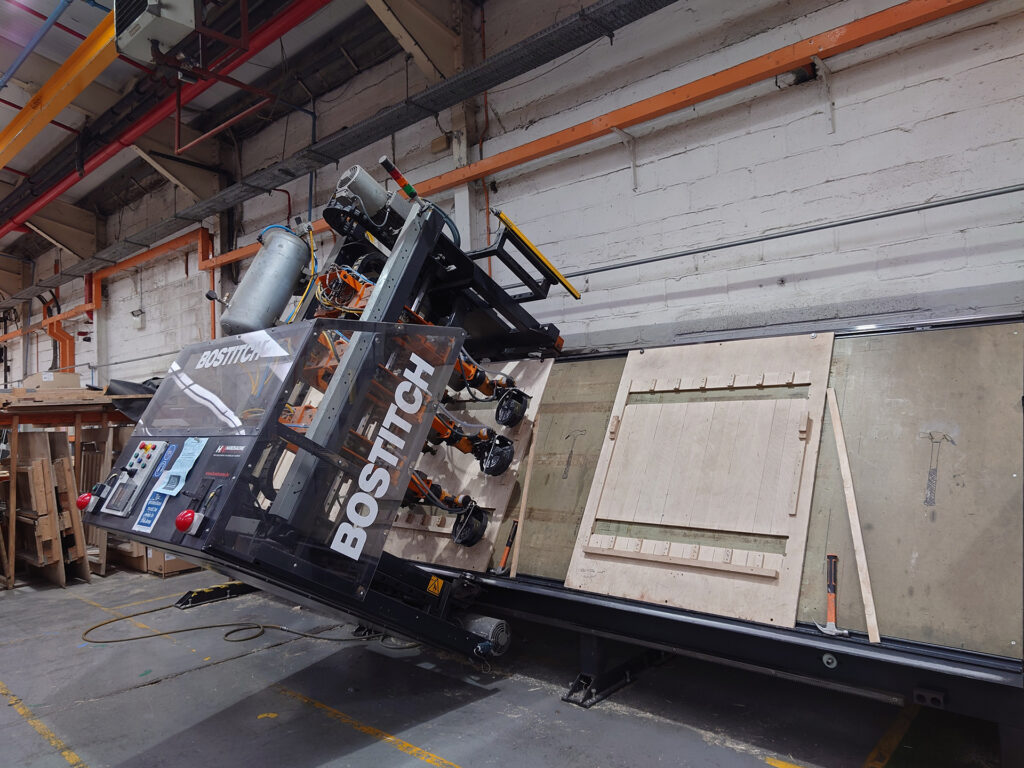 Automated nailing machine building a pallet at APS Packaging