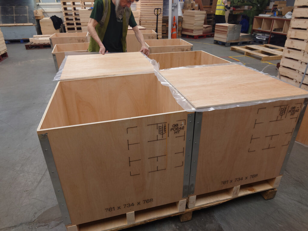 Plywood riveted cases being assembled