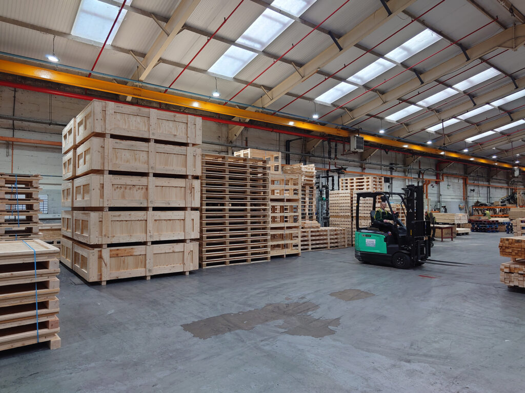 Crates, cases and pallets in the APS assembly hall, supplying Bridgwater
