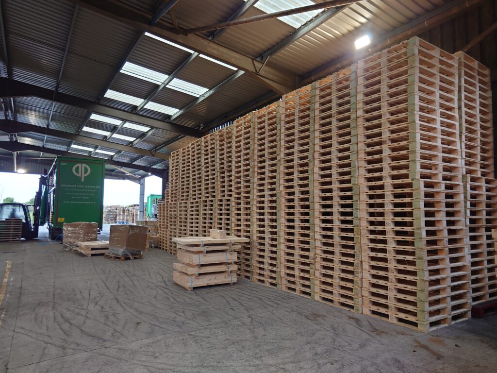 Stacks of new wooden pallets at APS Packaging, supplying Bodmin