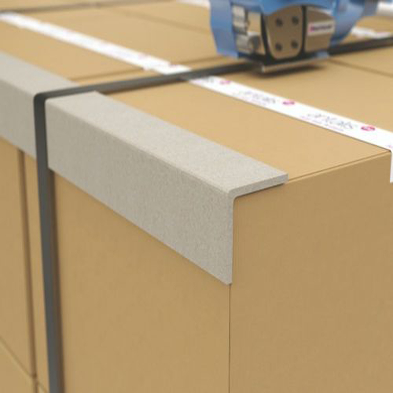 Cardboard edge protector under strapping on a palletised load