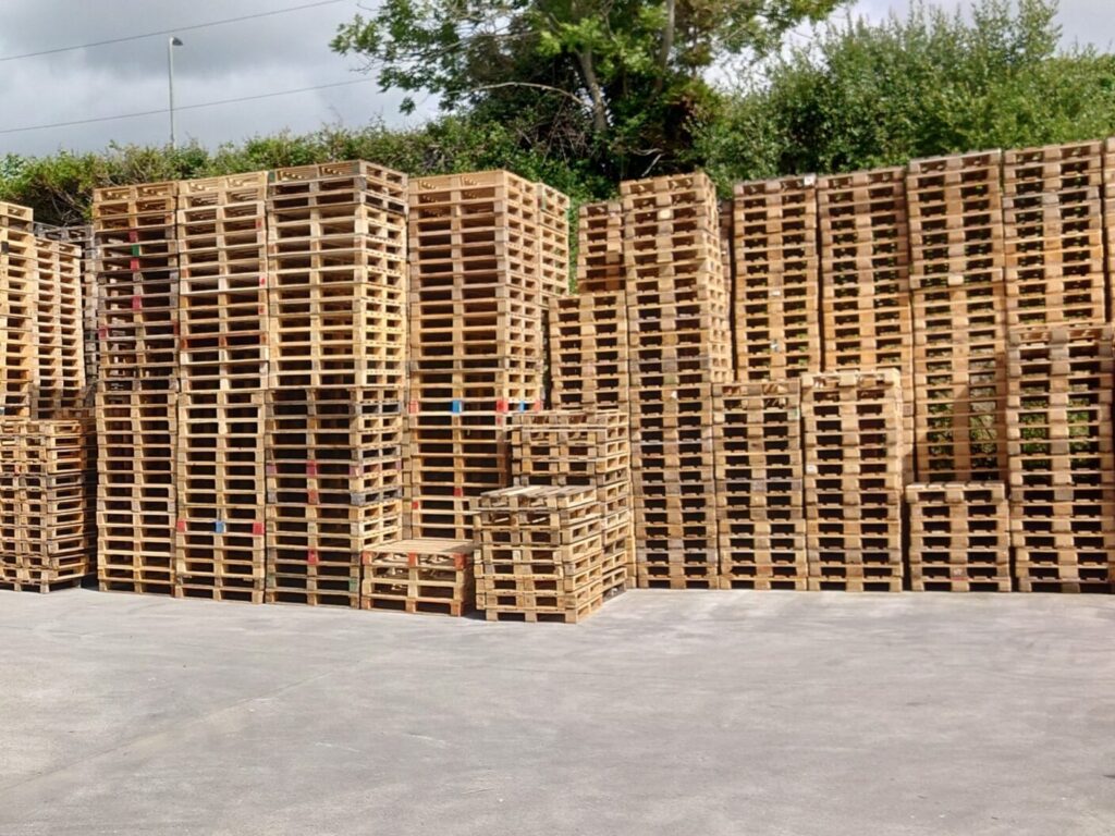 Stacks of used pallets in the APS Packaging yard